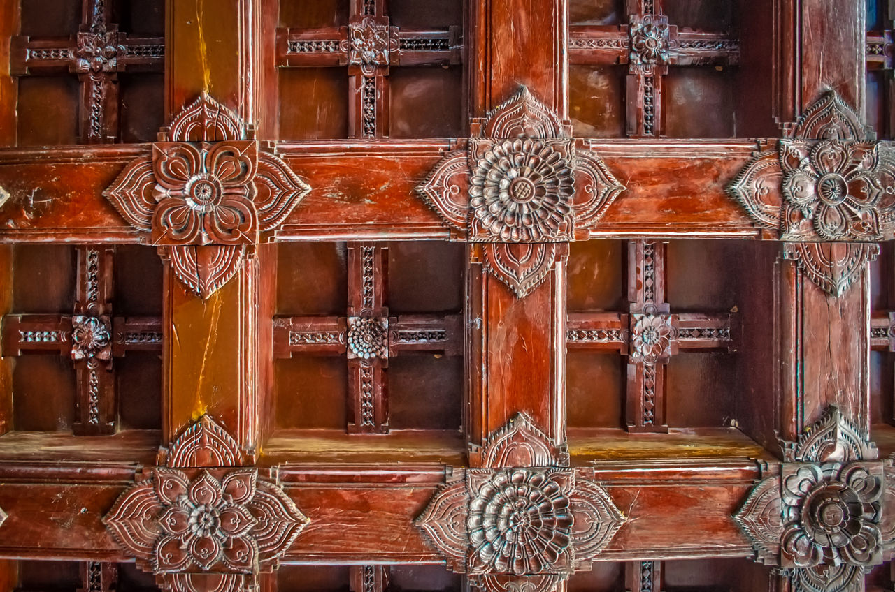 Traditional woodwork on the ceiling of old building in Kerala, India.